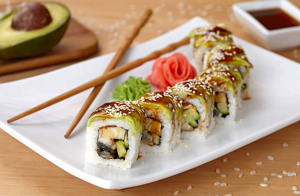 Green dragon sushi roll with eel, avocado, cucumber, wasabi and stock photo