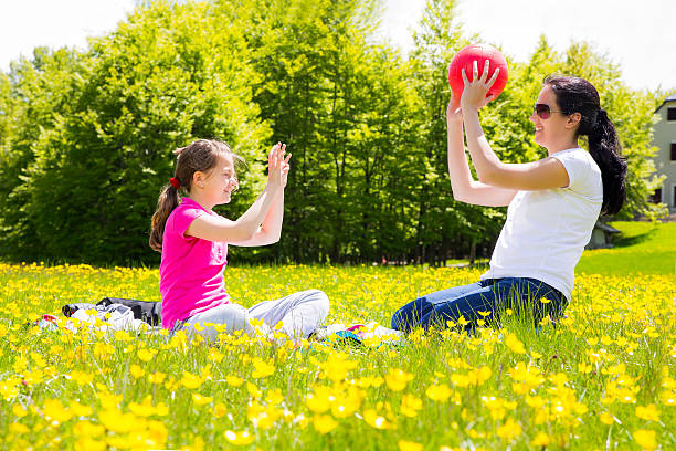 istock Young mother with her children playing with a ball 506104505