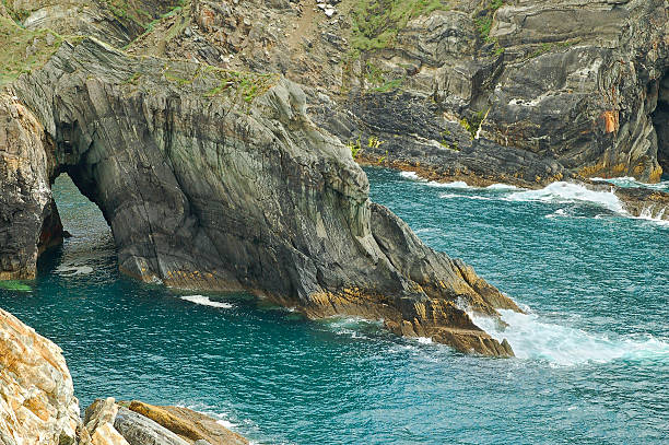 Mizen Head cliffs Stone arch at the coast of Ireland at Mizen Head, County Cork mizen head stock pictures, royalty-free photos & images