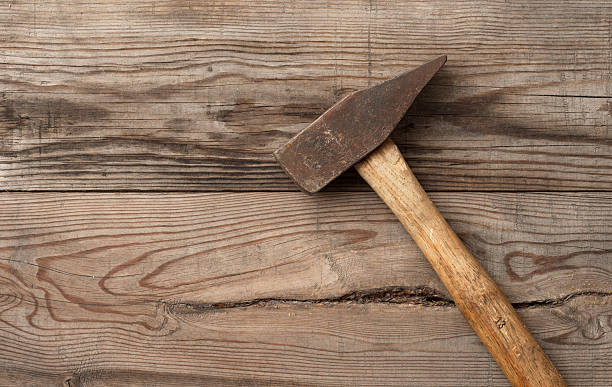 istock Old retro hammer on wooden workbench 506105616