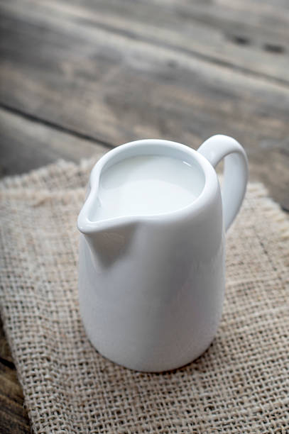 istock Cup of milk on wooden table 506105692
