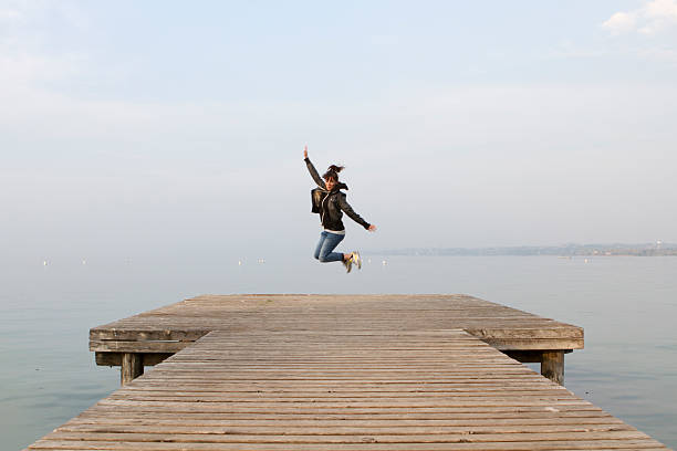 istock Woman Jumping on a Pier 506106409