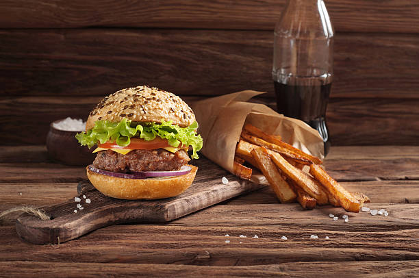 istock Burger with fries on a dark wooden rustic background 506106468