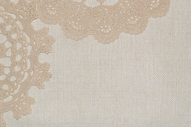 istock Crochet lace on linen background 506106882