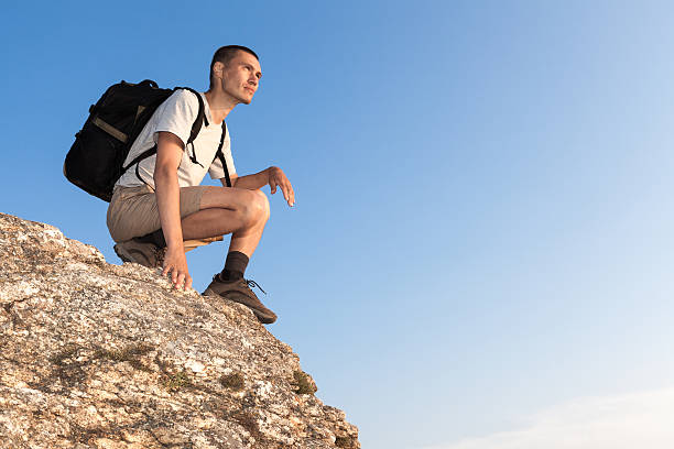 istock Backpacker on a rock looking into the distance 506107073