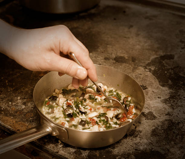 Chef is stirring risotto