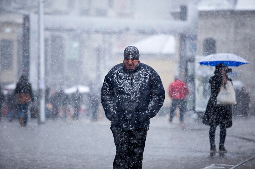 Istanbul,Turkey - February 17,2015 : Unidentified people walks in Istiklal Street under heavy snow in istanbul