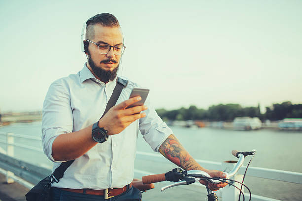 istock Businessman Push Bicycle and Using Smartphone 506116770