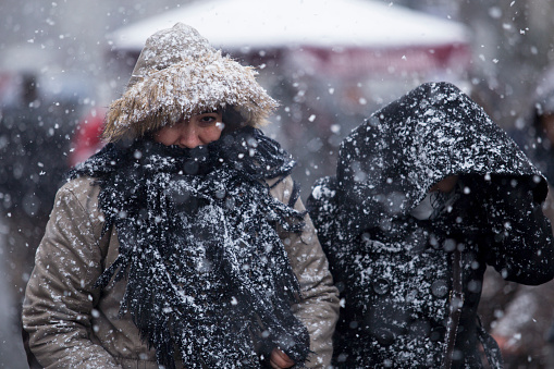 Istanbul,Turkey - February 17,2015 : Unidentified people walks in Istiklal Street under heavy snow in istanbul