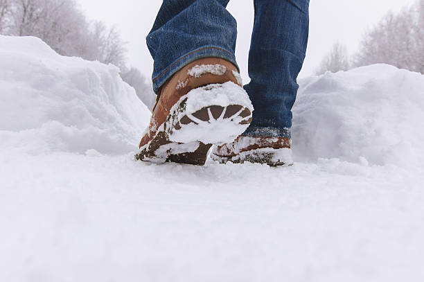 istock Man walks with boots through deep snow in  winter day. 506117928