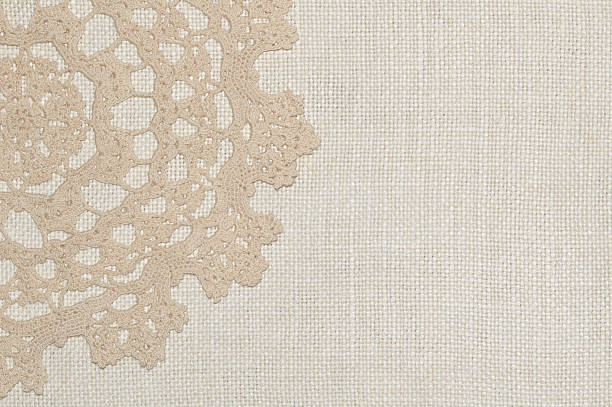 istock Crochet lace on linen background 506118798