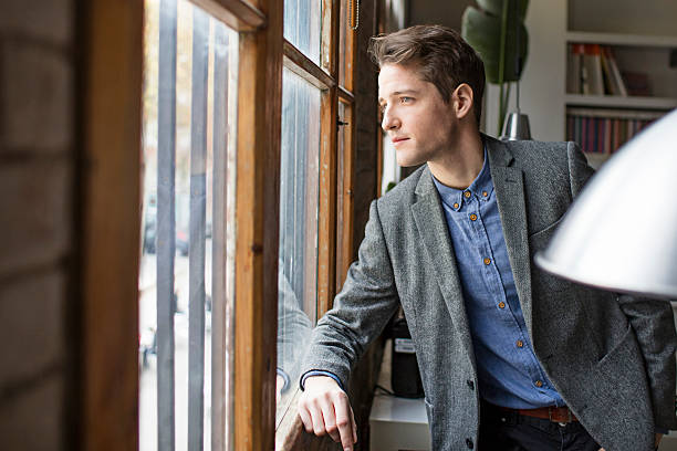 istock Businessman looking out the office window 506119102