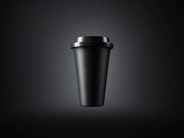 Black paper cup with plastic top on the dark background