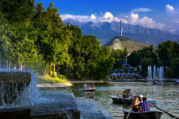 People boating on the lake in a city park Almaty Almaty, Kazakhstan - August 10, 2014. People boating on the lake. Central City Park of the city of Almaty - one of the biggest in the city. Its area is 42 hectares. It was founded in 1856. The park created two artificial pond. At one installed water park attractions, the other can be katattsya boats, water bikes. almaty photos stock pictures, royalty-free photos & images