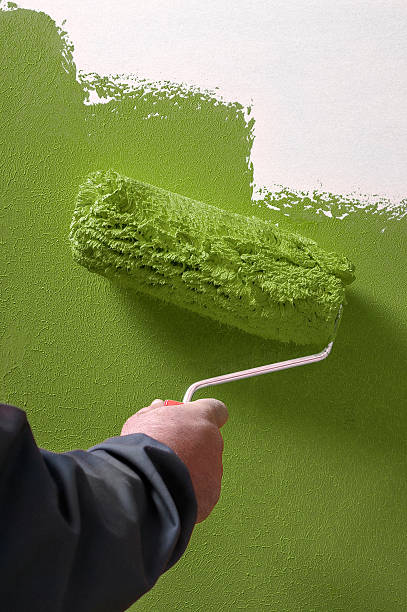 istock Smooth concrete wall hand painting with paint roller - painter 506120328