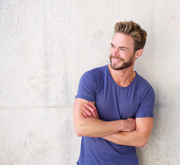 istock Smiling confident guy with beard posing with arms crossed 506121384