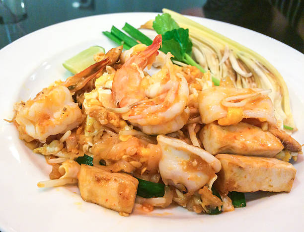 istock Stir-fried Rice Noodles with Shrimp and Squid in White Plate 506122548