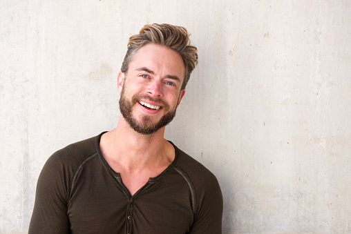 Close up portrait of a handsome man with beard smiling