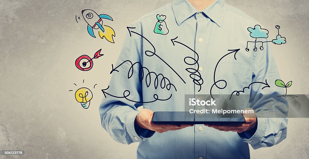 Arrows erupting from a tablet computer Arrows erupting from a tablet computer held by a  young man Adult Stock Photo
