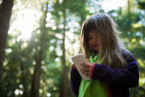 istock Child usuing a smart phone in nature 506124038