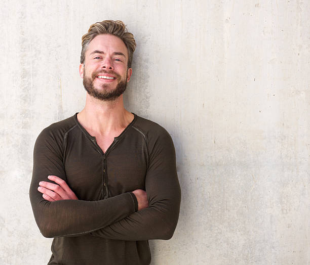 istock Handsome man laughing with arms crossed 506124142