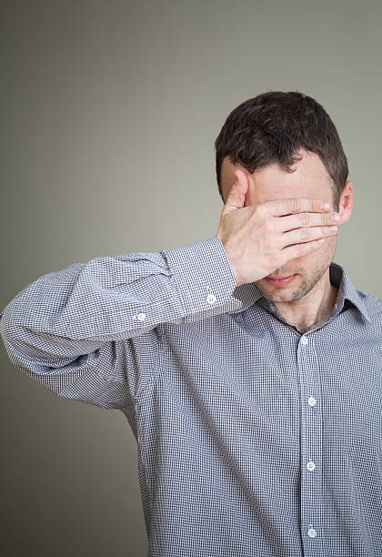 istock Young sad Caucasian man hiding his face with hand 506128841