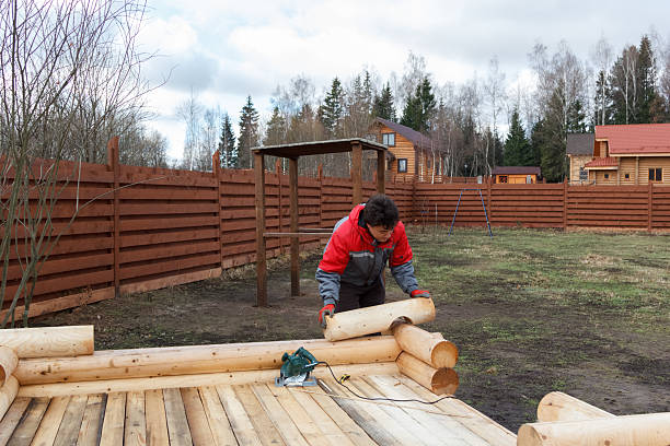 istock man builds structure made of logs 506130066