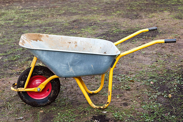 istock dirty metal garden wheelbarrow on bare ground 506130116