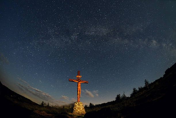 istock cross under milky way in Ceahlau mountain 506130670