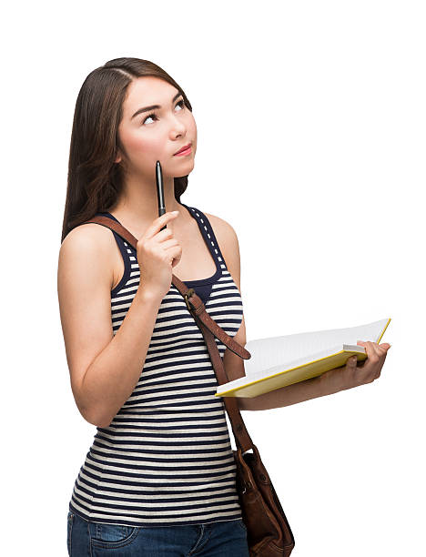 istock Thoughtful latin studen holding pen to face 506130704