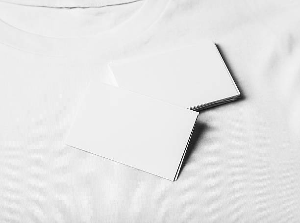istock Closeup of set business cards on white tshirt. Horizontal 506131904