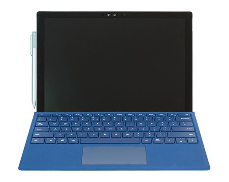Krakow, Poland - January 19, 2016: Microsoft Surface Pro 4 - Windows tablet with bundled stylus Surface Pen and dedicated keyboard (Type Cover) attached.