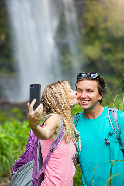 istock Couple having fun taking pictures together outdoors on hike 506132725