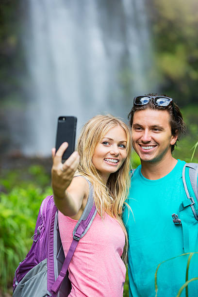 istock Couple having fun taking pictures together outdoors on hike 506132823