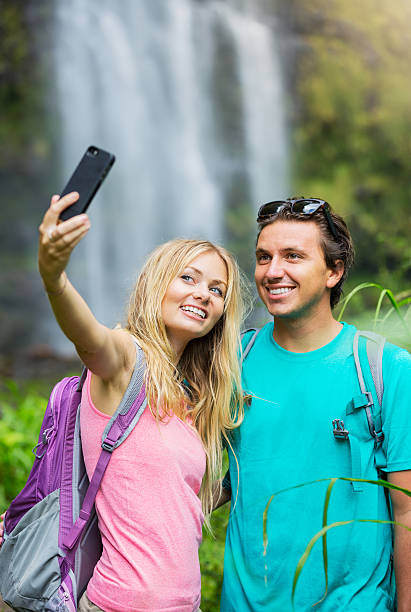 istock Couple having fun taking pictures together outdoors on hike 506132857
