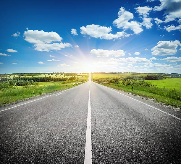 istock Asphalt road in field under blue sky 506132973