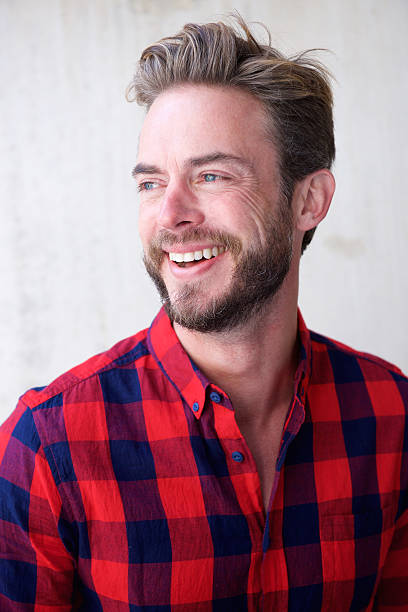istock Handsome man with beard smiling and looking away 506133532