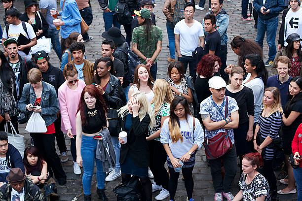 Group of serious college students in the university amphitheatre, they are standing and looking at camera.   