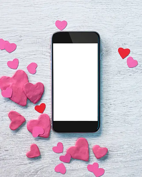 Photo of Smartphone with heap of small hearts