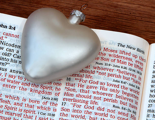 istock Religious: open Bible Scripture of John 3:16 with white heart 506135552