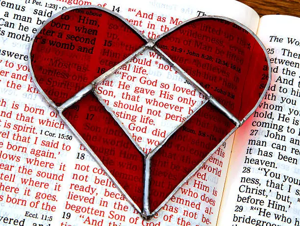 Photo of Religious: open Bible Scripture of John 3:16 with red heart