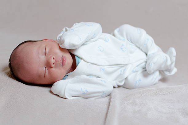 Chinese Newborn Baby Sleeping On His Side Stock Photo - Download