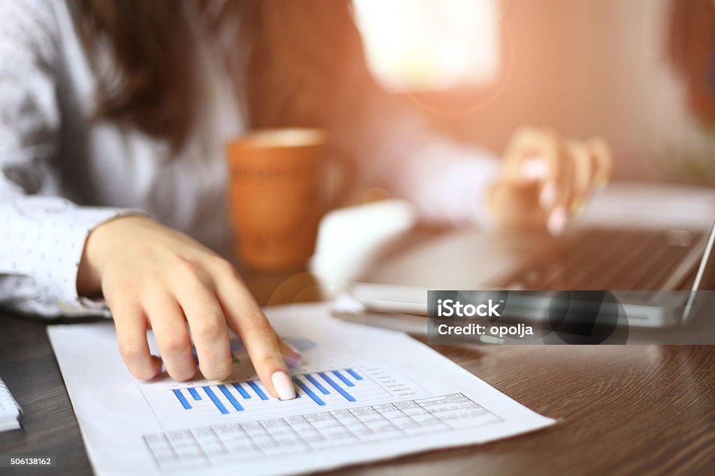 Hands of financial manager taking notes when working on report Hands of financial manager taking notes when working Adult Stock Photo