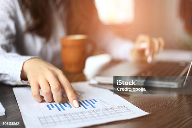 Hands Of Financial Manager Taking Notes When Working On Report Stock Photo - Download Image Now