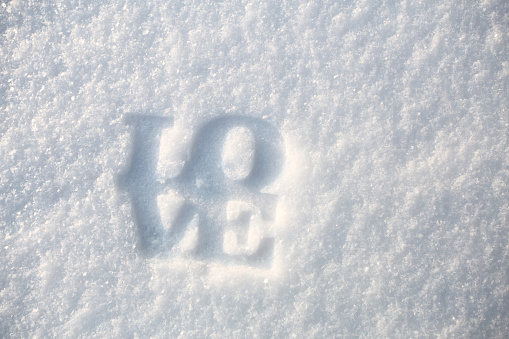 Love word on white snow on Valentine's day