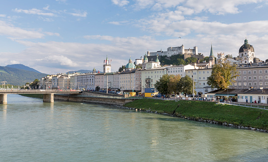 Cityscape with Salzach river, Staatsbrucke bridge, Dom Cathedral and fortress Hohensalzburg in Salzburg, Austria.