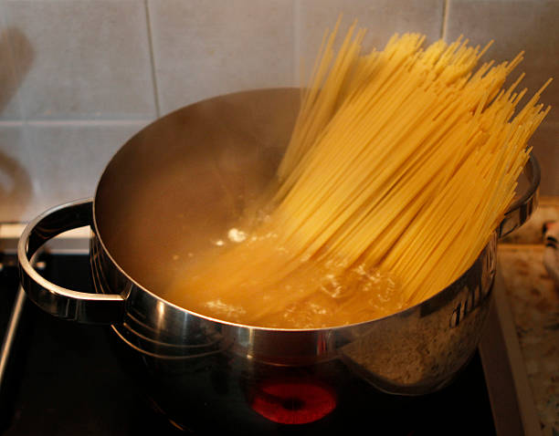 istock cooking spaghetti on oven stove 506144780