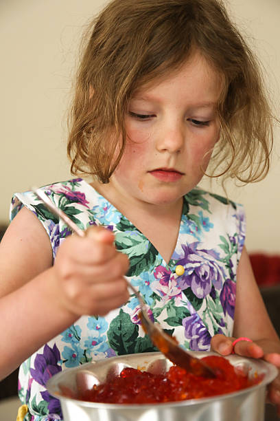 istock Young child having fun eating jelly from a spoon 506145560