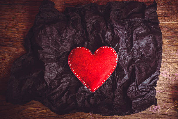 istock Red heart in black paper 506145748
