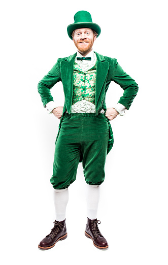 A portrait of a stereotypical Irish character all ready for Saint Patricks day.  He smiles, his arms akimbo on his hips.  Isolated on white studio background.